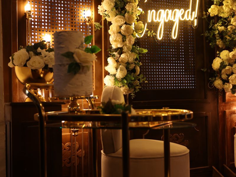 Engagement celebration space with flowers and warm lighting