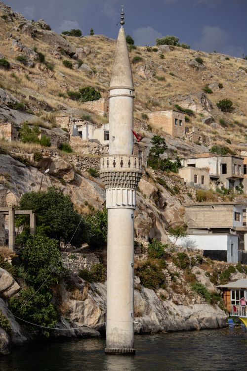 Free The unique minaret of a submerged mosque in Halfeti, Şanlıurfa, Turkey, emerging from the water. Stock Photo