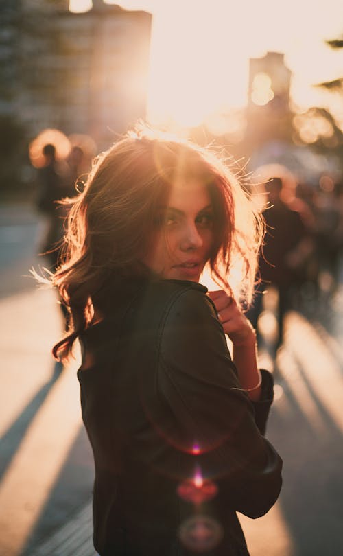 Free Photo of Woman Posing in Sun Glare Stock Photo