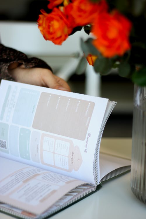 Close-up of a Person Looking Through a Planner 