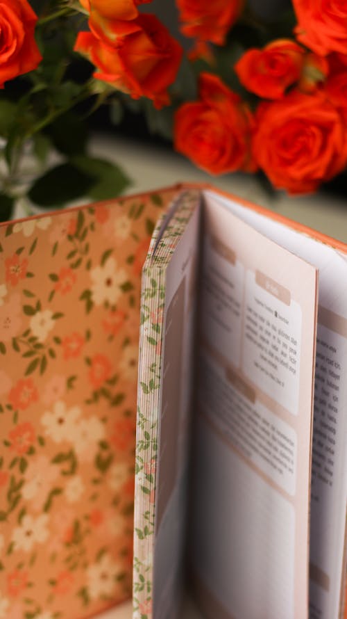 A book with a flower pattern on it and orange flowers