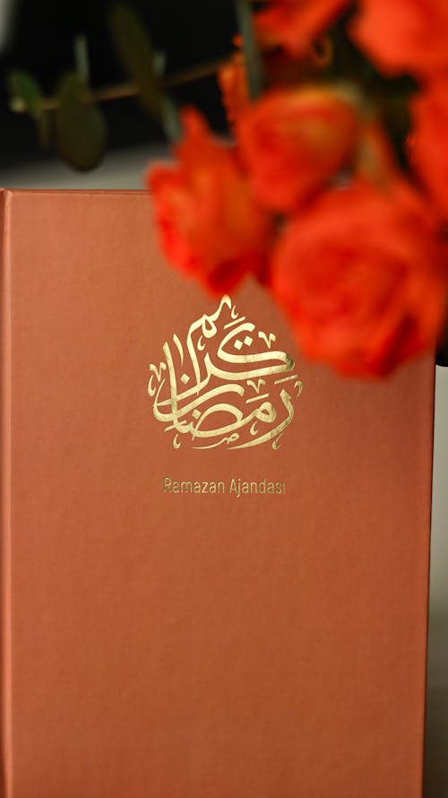 A book with a red cover and roses on it