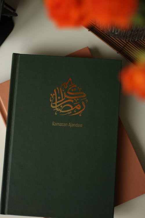 A green book with the word islamic on it