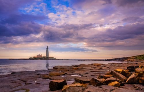 Free Stunning view of St. Mary's Lighthouse and rocky coastline at dusk. Stock Photo