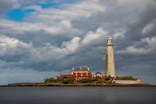 Free St Mary's Lighthouse under dramatic skies on the UK coastline. Stock Photo