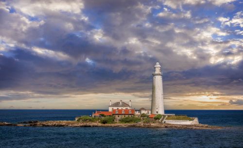 Free Ethereal scene of St Mary's Lighthouse surrounded by dramatic skies at dusk. Stock Photo