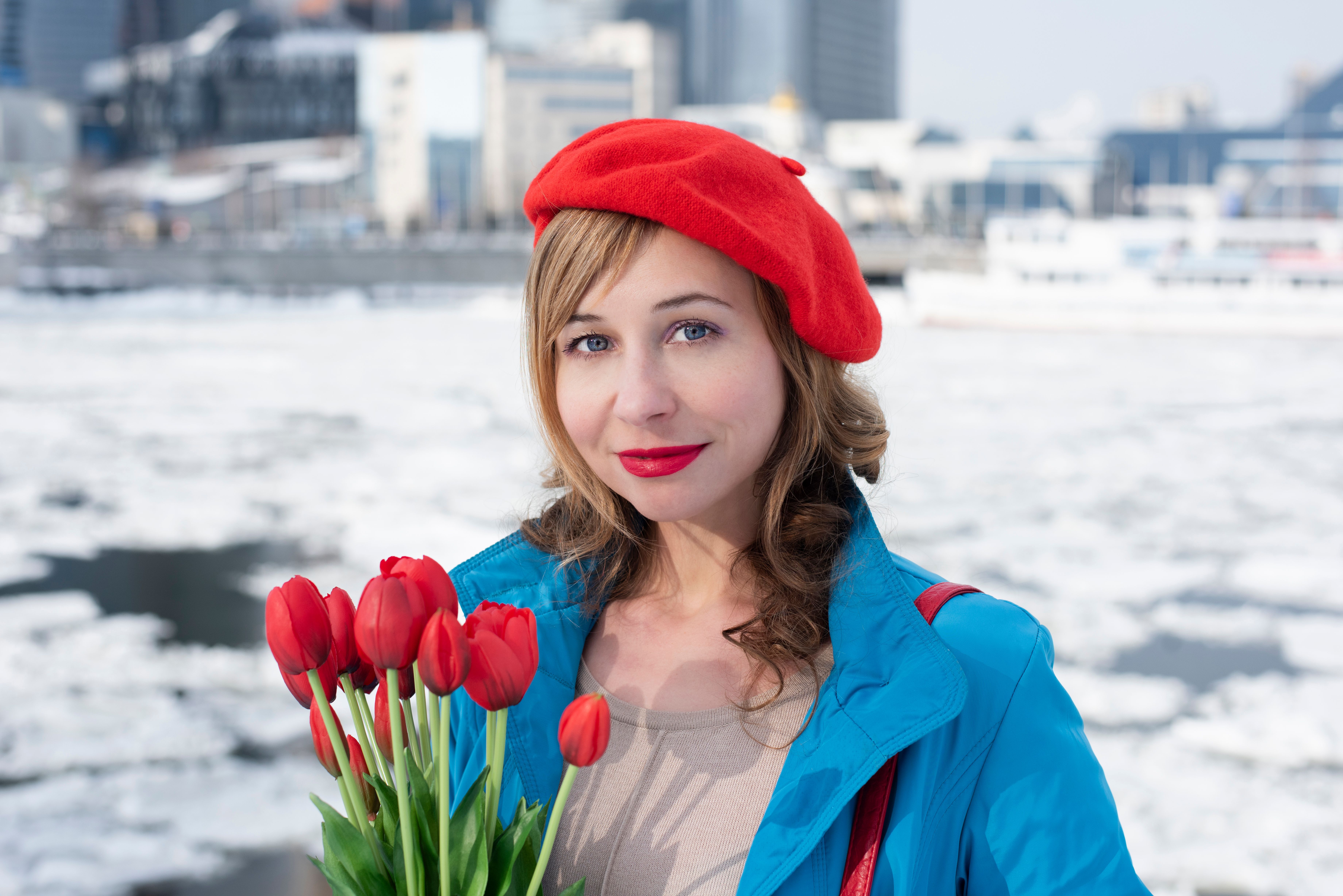 A Woman Wearing a Blue Jacket and Red Beret Standing Outside in Winter ...