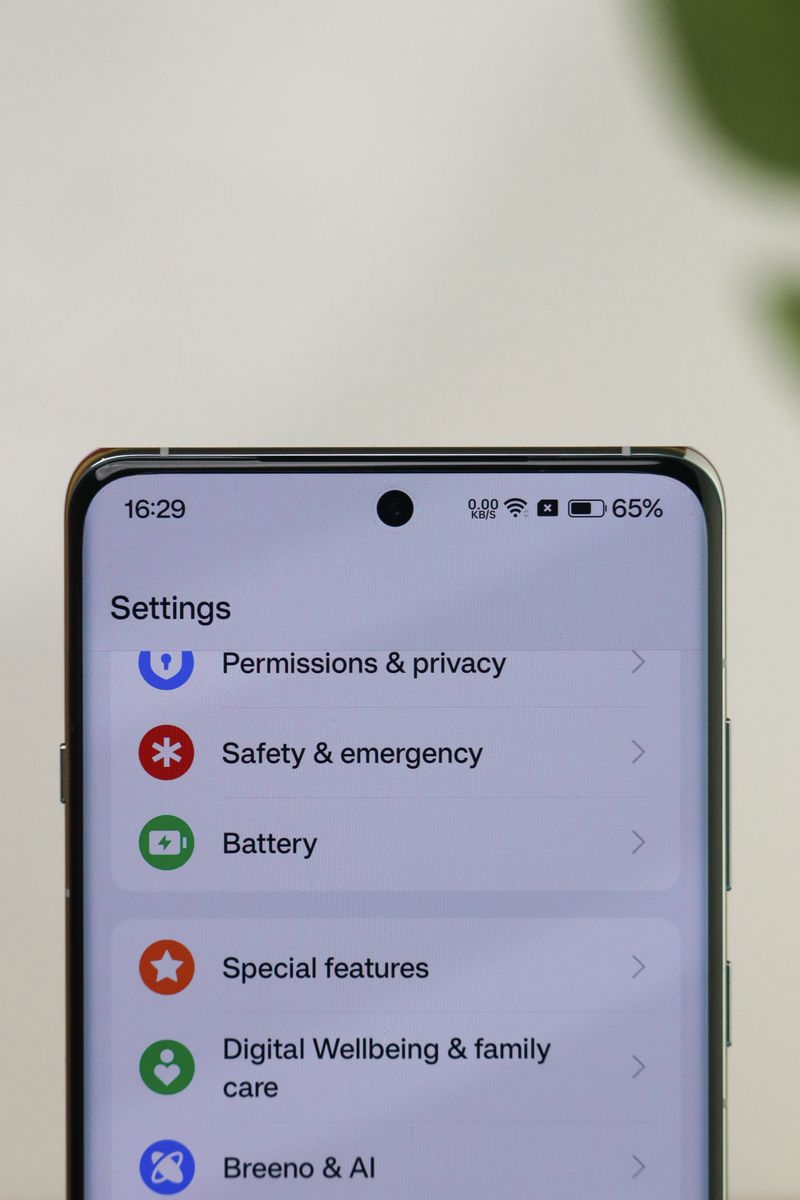 A person holding a smartphone with a push notification permission dialog appearing on screen during app setup