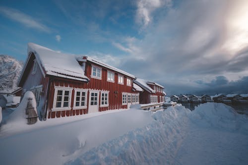 A house covered in snow with a blue sky
