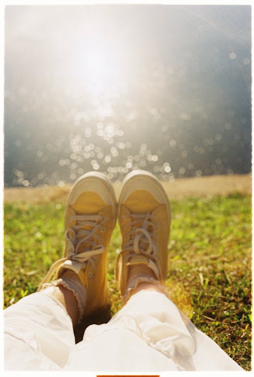 Feet in Sneakers on Lakeshore