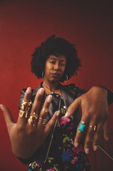 时尚女性与非洲裔模特在红色背景下大胆展示戒指和珠宝