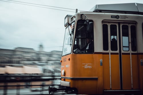 A train is traveling down the tracks in a city