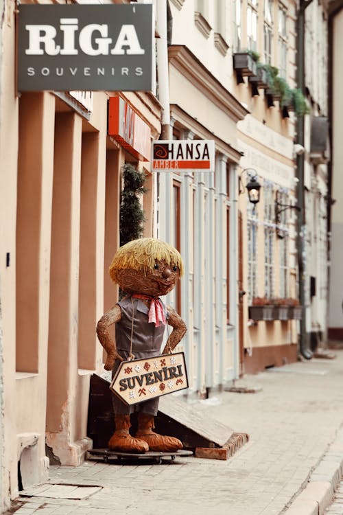 Doll with Gift Shop Advertisement on Sidewalk in Riga