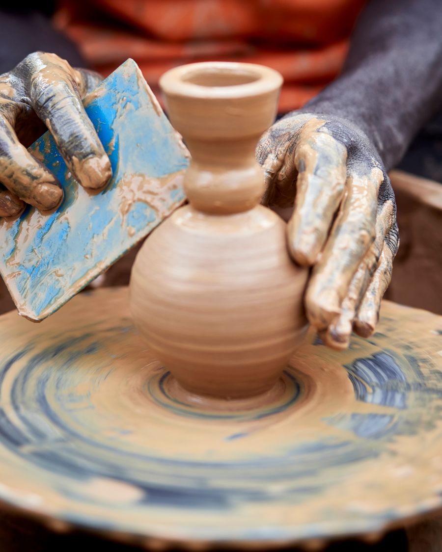 Hands shaping a clay pot on a pottery wheel — Marafaphotos on Pexels