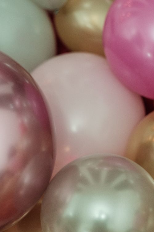 Free A vibrant mix of balloons in pink, gold, and pastel colors perfect for parties. Stock Photo