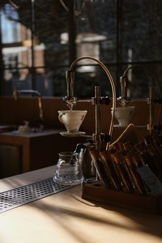 Warm coffee shop setting with brewing equipment and soft lighting.
