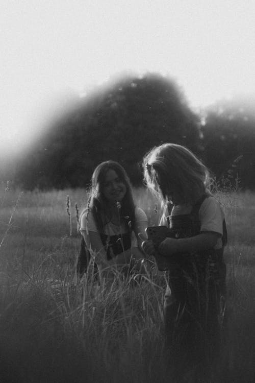 Two girls in a field with a black and white photo