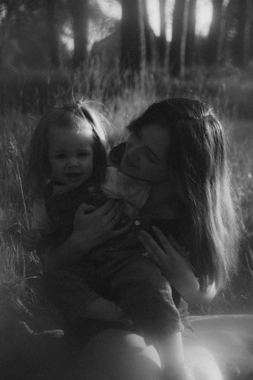 A black and white photo of a woman holding a child