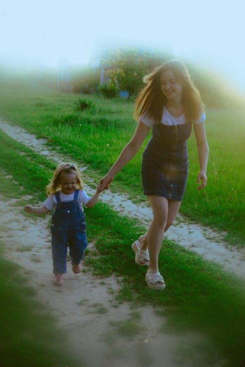 A woman and child walking down a path