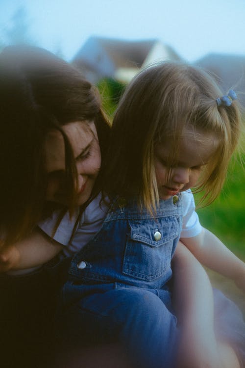 A woman holding a child in a field