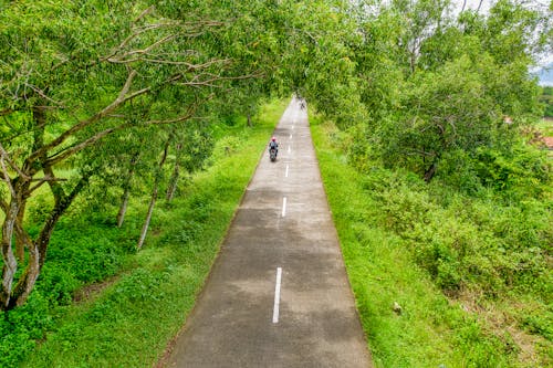 Aerial Photography Of Man Riding Motorcycle Along Road