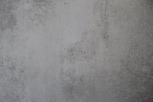 A gray wall with a white background and a gray floor
