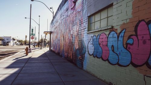Free Colorful graffiti art on a city street brick wall on a sunny day. Stock Photo