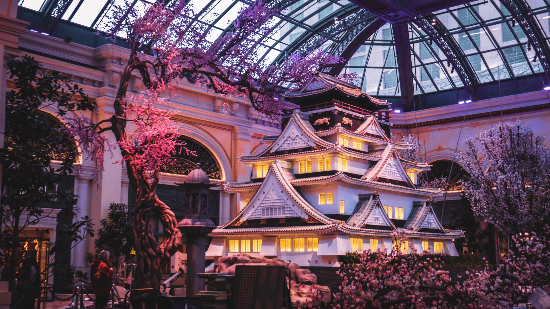 Stunning indoor replica of a Japanese castle surrounded by cherry blossoms.