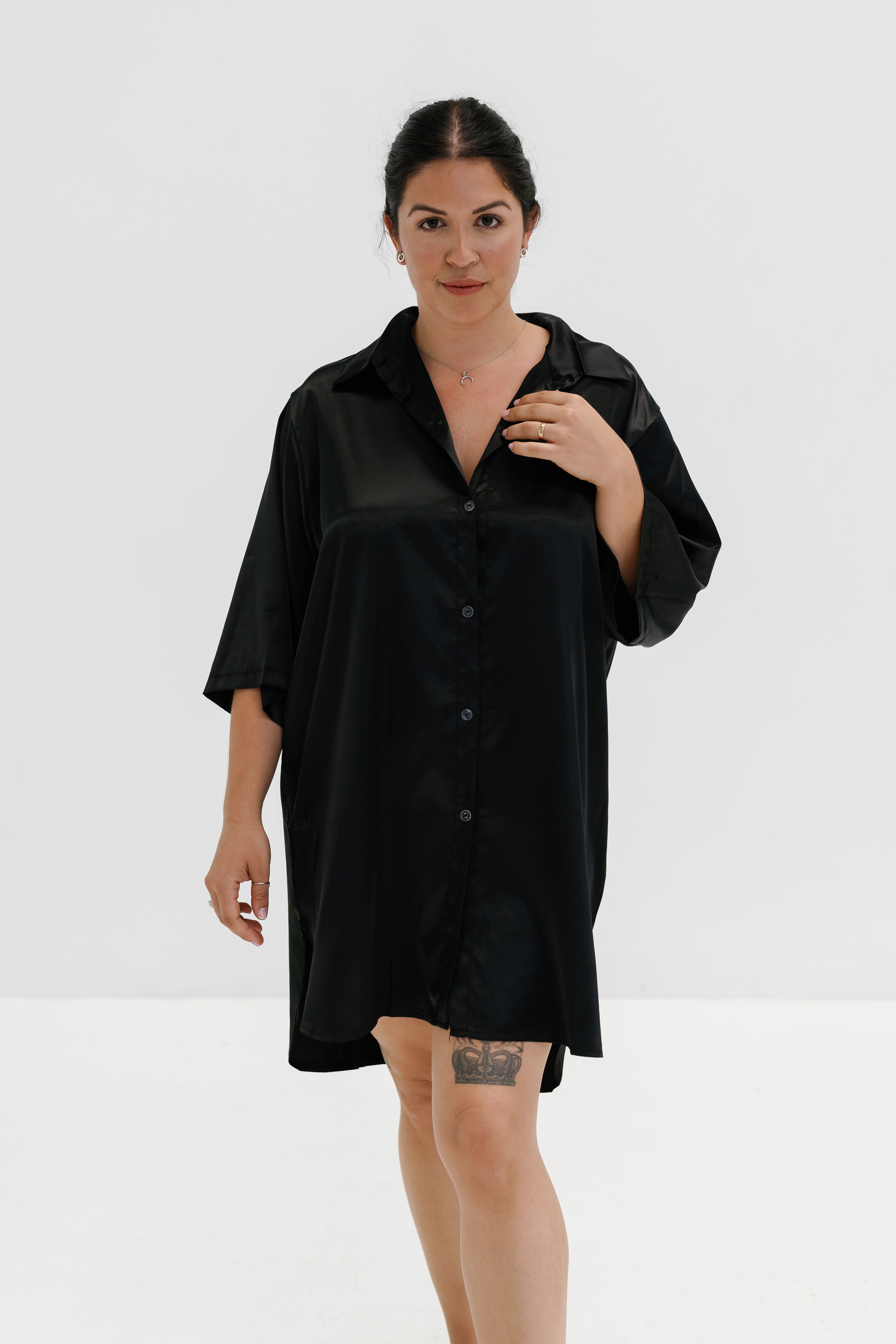 Woman in a black silk shirt dress, elegant day to night look