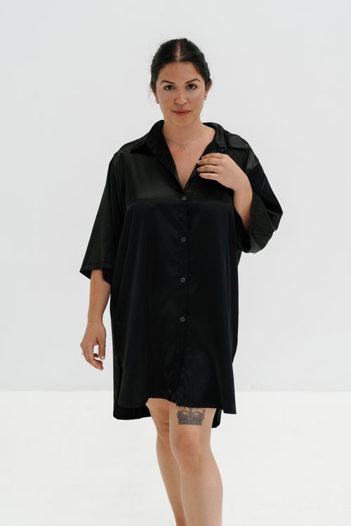 Woman in a black silk shirt dress, elegant day to night look