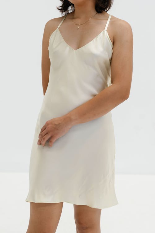 A woman in a white slip dress