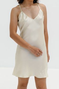 Woman in a silky slip dress showcasing minimalist elegance and modern fashion.