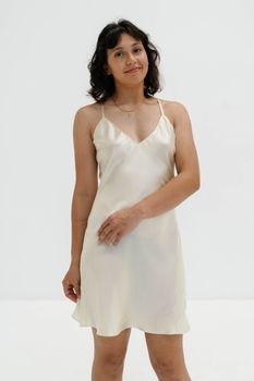 Portrait of a woman in a silky dress showcasing elegant fashion.