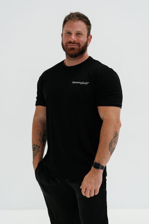 A man in black t - shirt and black pants