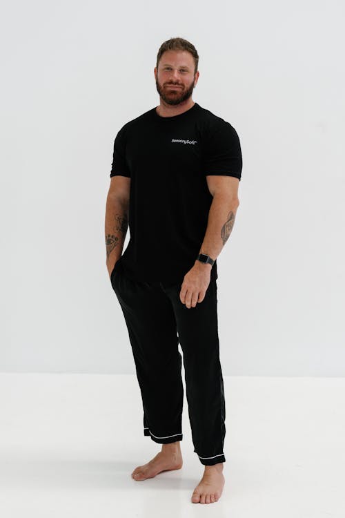 A man in black pajamas and a beard