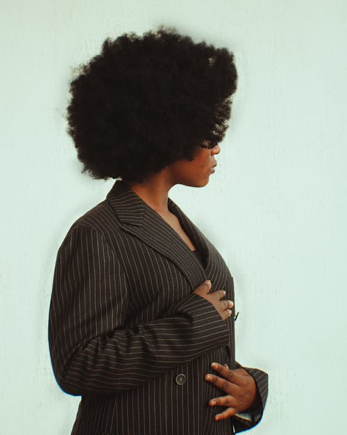 A woman with an afro wearing a suit