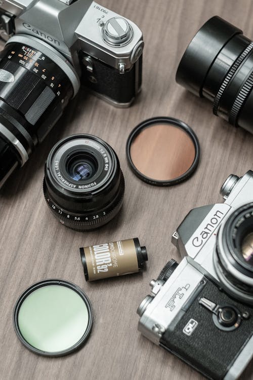 A variety of cameras and lenses on a table