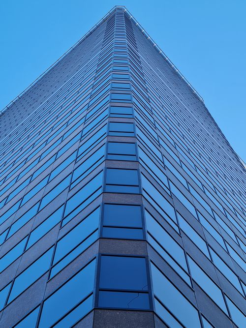 Free Low angle view of a tall, modern skyscraper in Buenos Aires, Argentina, under a clear blue sky. Stock Photo