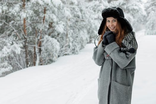 A Beautiful Woman Wearing a Trapper Hat and Gray Coat