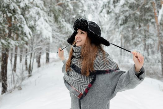 A Playful Woman Pulling the Strings of Her Trapper Hat