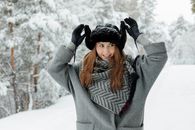 A Woman Playing with the Flaps of Her Trapper Hat