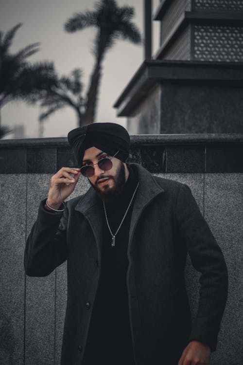 Model Dressed in Black Looking over Sunglasses