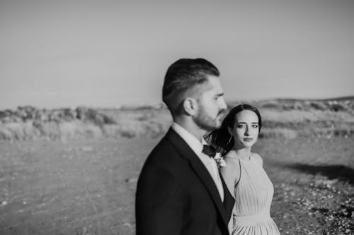 A bride and groom standing in the desert