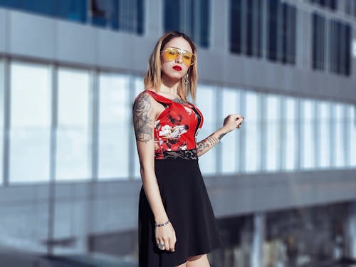 Woman In Red And Black Floral Sleeveless Dress