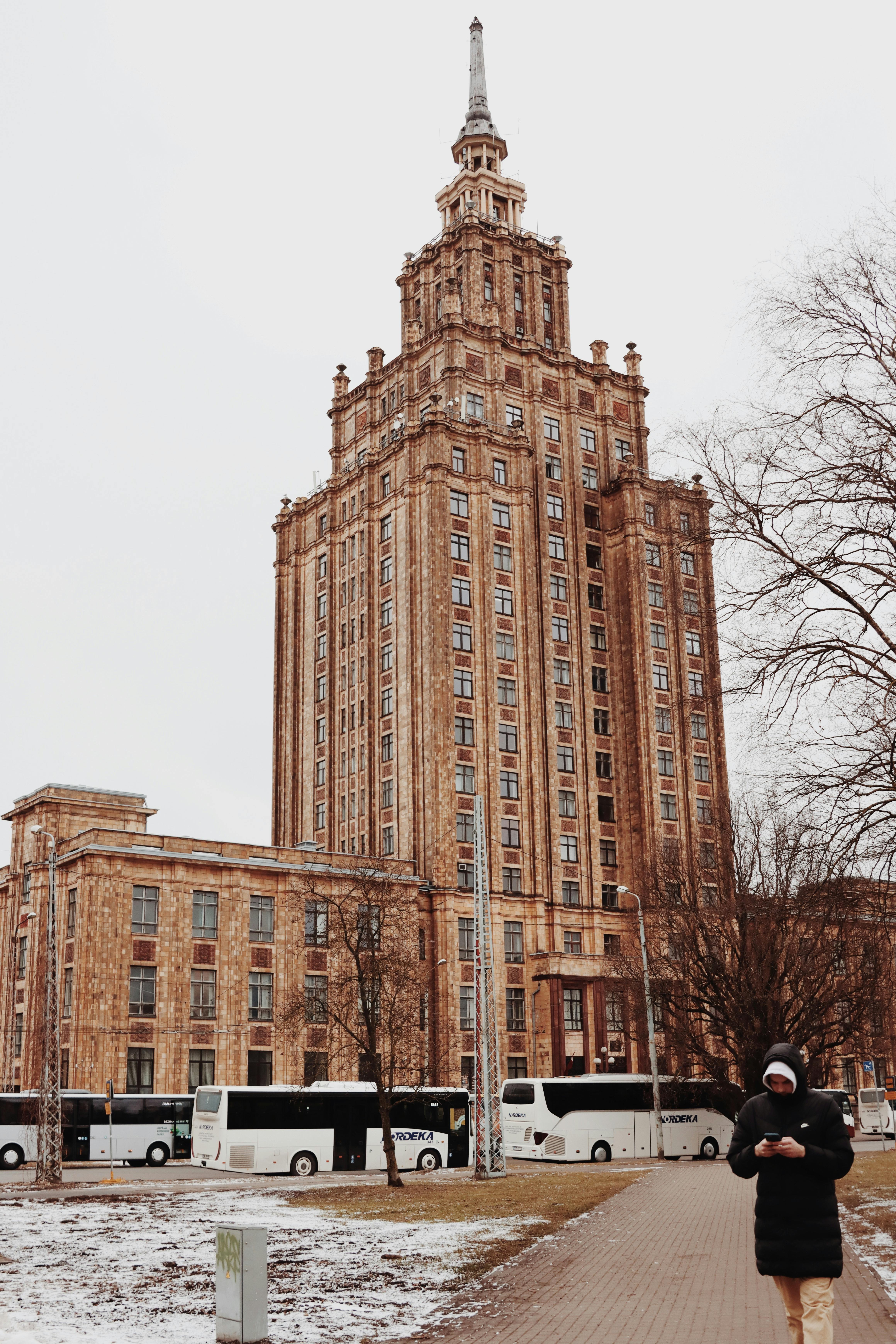Stunning Soviet-style building in wintertime Riga, Latvia with snowy surroundings.
