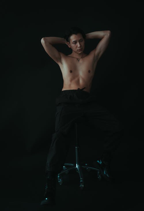 Topless Man Posing on Chair