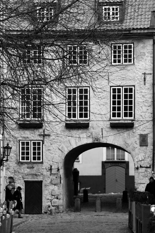 Free Black and white photo of a historic stone building with archway in Riga, Latvia. Stock Photo
