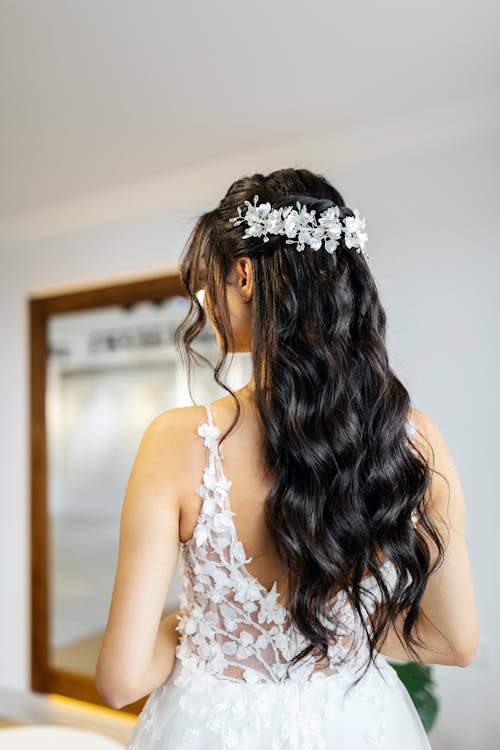 A bride with long hair wearing a wedding dress