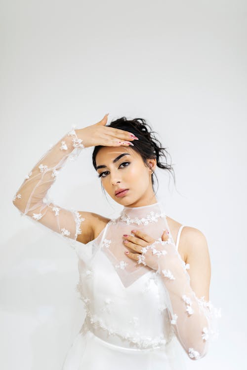 Studio Shot of a Woman in a Wedding Dress with Mesh Gloves 