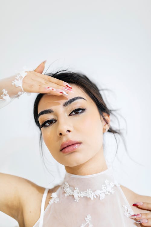 Studio Shot of a Woman in a Wedding Dress with Mesh Gloves 